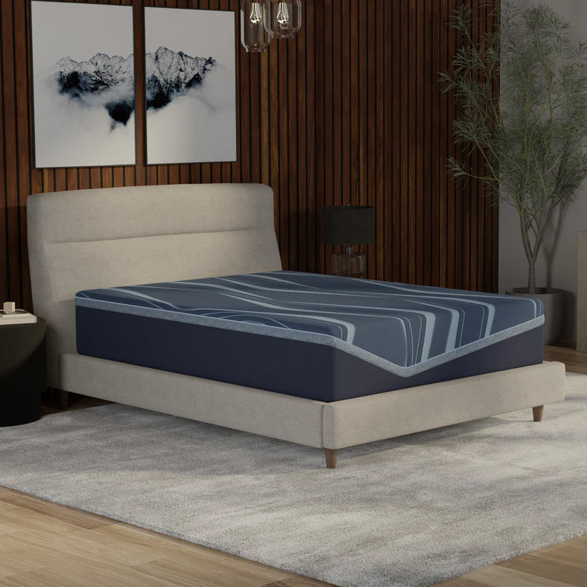 Blue mattress on a bed in a bedroom setting with decor elements.