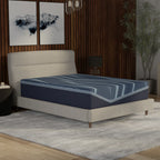 Blue mattress on a bed in a bedroom setting with decor elements.