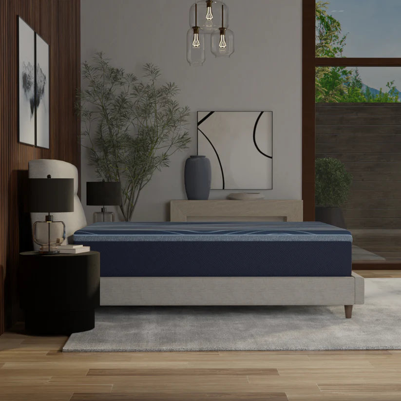 Bed with a blue mattress in a modern bedroom setting