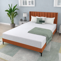 Bedroom with a bed featuring a wooden headboard, white bedding, and green throw blanket.