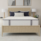 Bed with white mattress, beige headboard, and decorative pillows in a bedroom setting.
