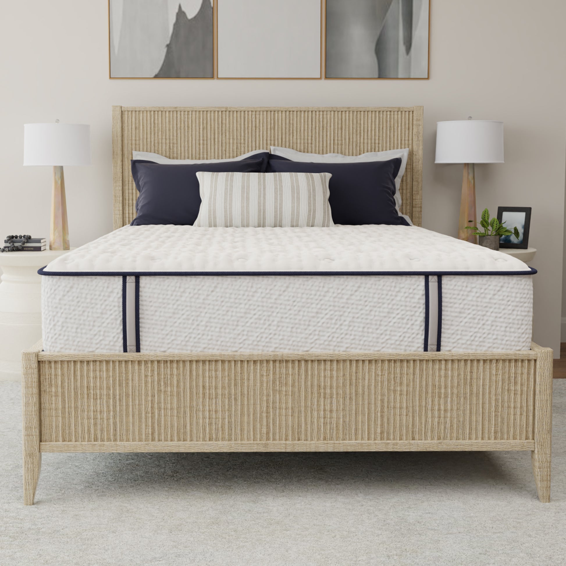 Bed with white mattress, beige headboard, and decorative pillows in a bedroom setting.