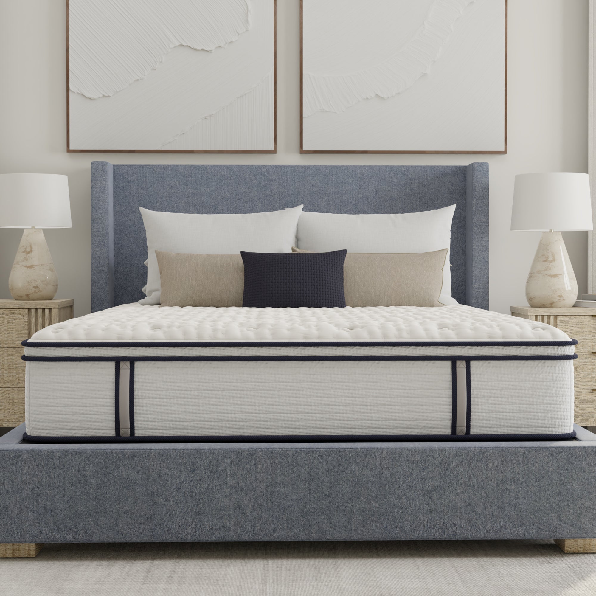 Mattress on a bed with pillows in a bedroom setting