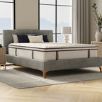 Gray upholstered bed with a mattress in a modern bedroom setting.