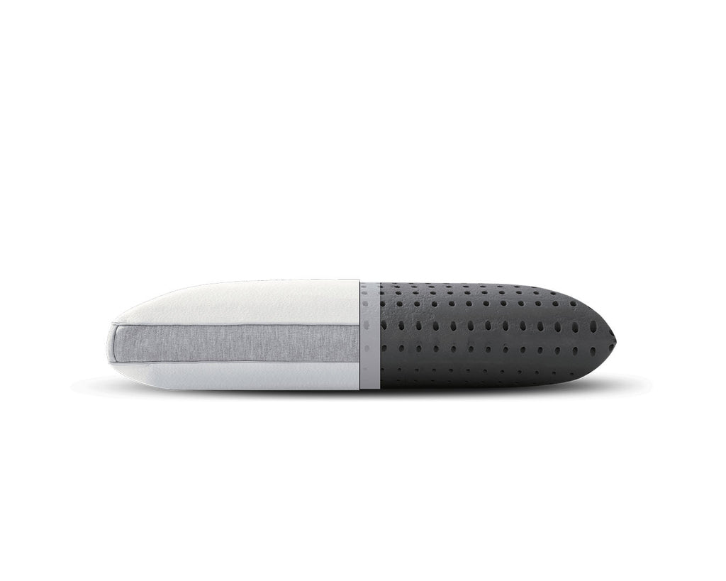 A modern capsule-shaped travel pillow with a white and light gray fabric-covered half and a dark gray perforated foam half, shown horizontally on a white background.