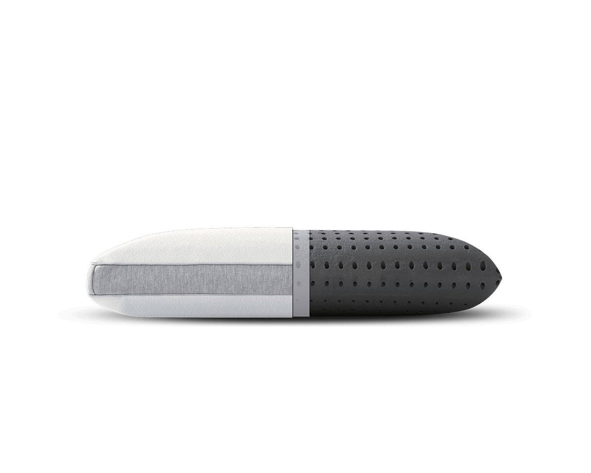 A modern capsule-shaped travel pillow with a white and light gray fabric-covered half and a dark gray perforated foam half, shown horizontally on a white background.