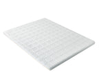 A white mattress topper or thin mattress pad with a quilted geometric pattern, shown at an angle on a solid white background.