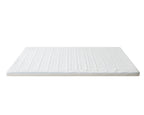 A white quilted mattress topper or mattress pad with a textured honeycomb pattern, shown from a high angle on a solid white background.
