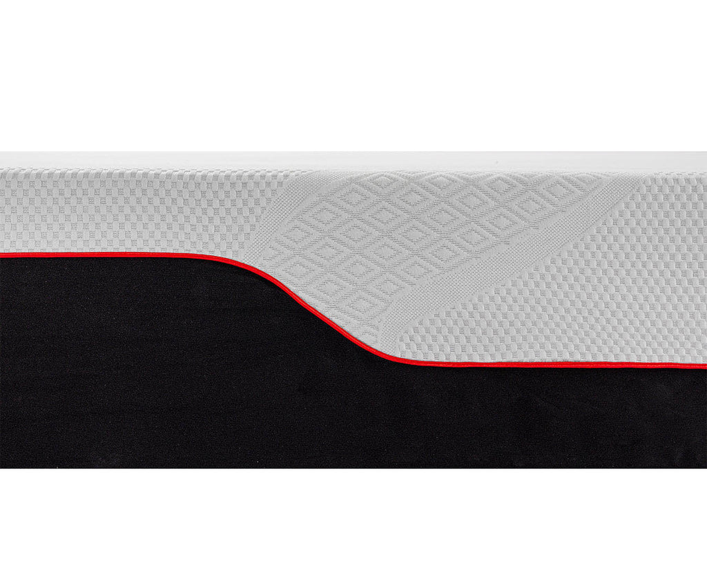 Close-up of a mattress or cushion showing a textured light gray top surface with a diamond pattern, a curved red edge, and a black lower section on a white background.